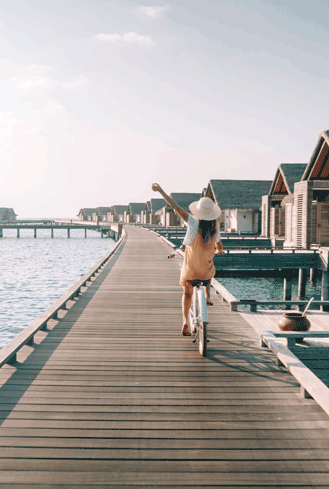 Girl cycling at hotel in Maldives
